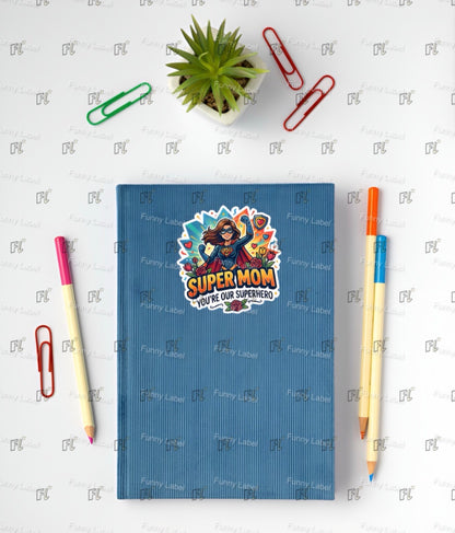Blue notebook with a 'Super Mom' sticker on a white background with stationery items.
