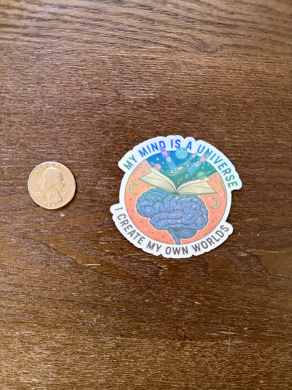Sticker with brain graphic and text on a wooden surface with a coin for scale