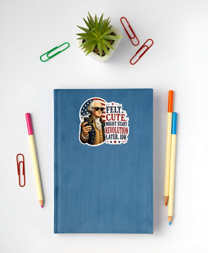 Blue notebook with a graphic design on a white surface with stationery items.