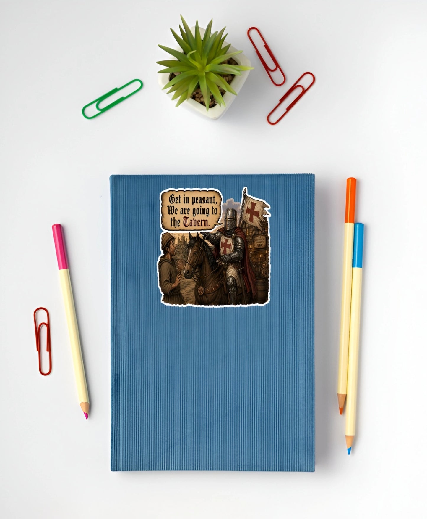 Get In Peasant We Are Going to the Tavern medieval knight sticker displayed on a blue notebook