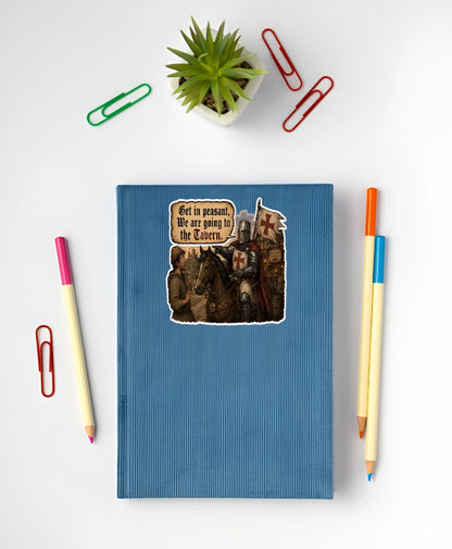 Get In Peasant We Are Going to the Tavern medieval knight sticker displayed on a blue notebook