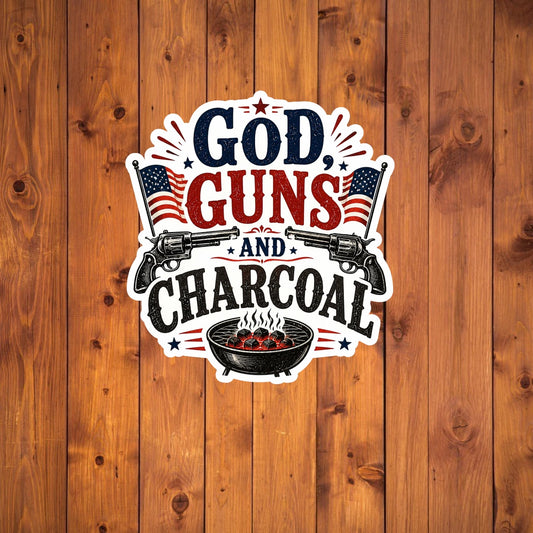 Sticker with 'God, Guns and Charcoal' text on a wooden background