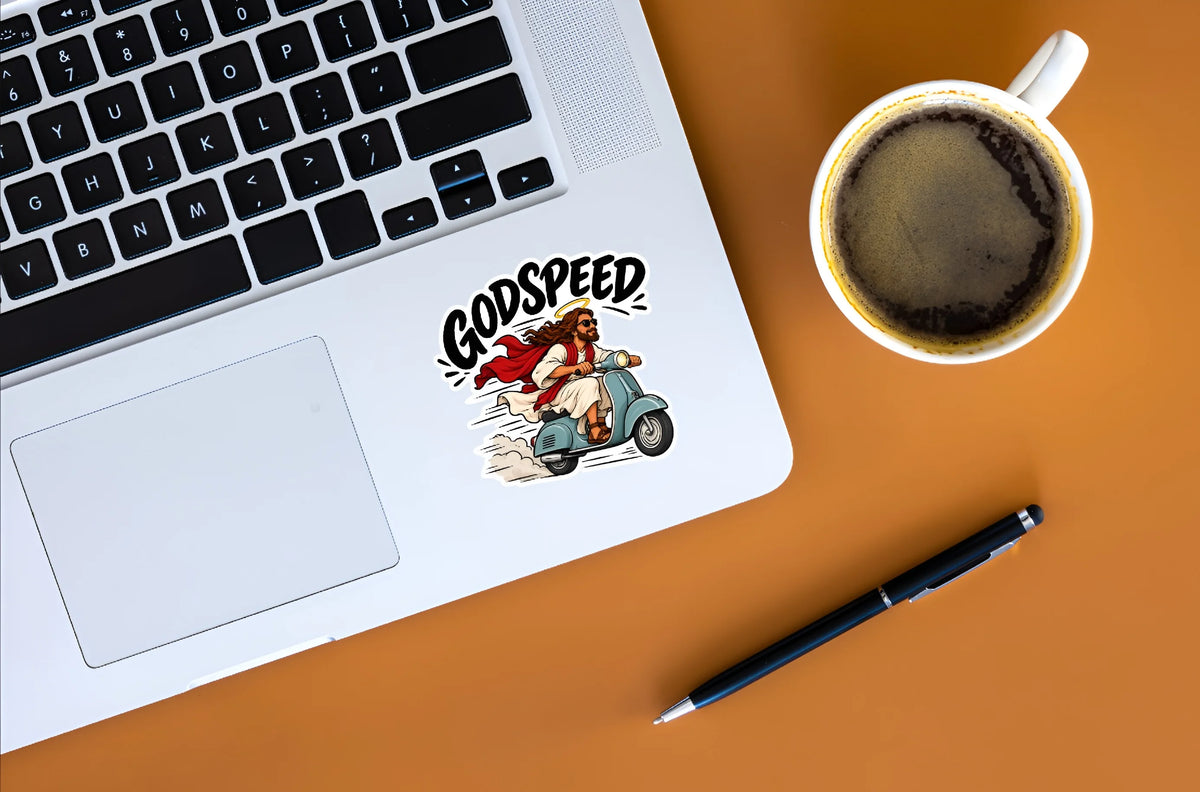Funny Jesus Godspeed scooter sticker displayed on a silver laptop beside a cup of coffee
