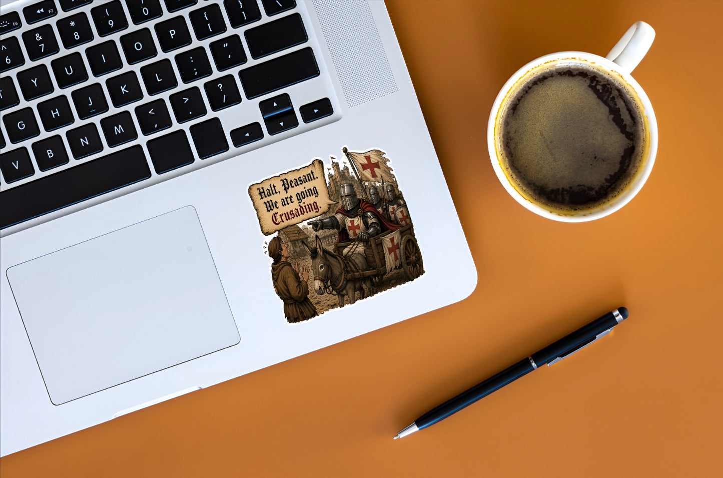 Halt Peasant We Are Going Crusading medieval knight sticker displayed on a silver laptop beside coffee