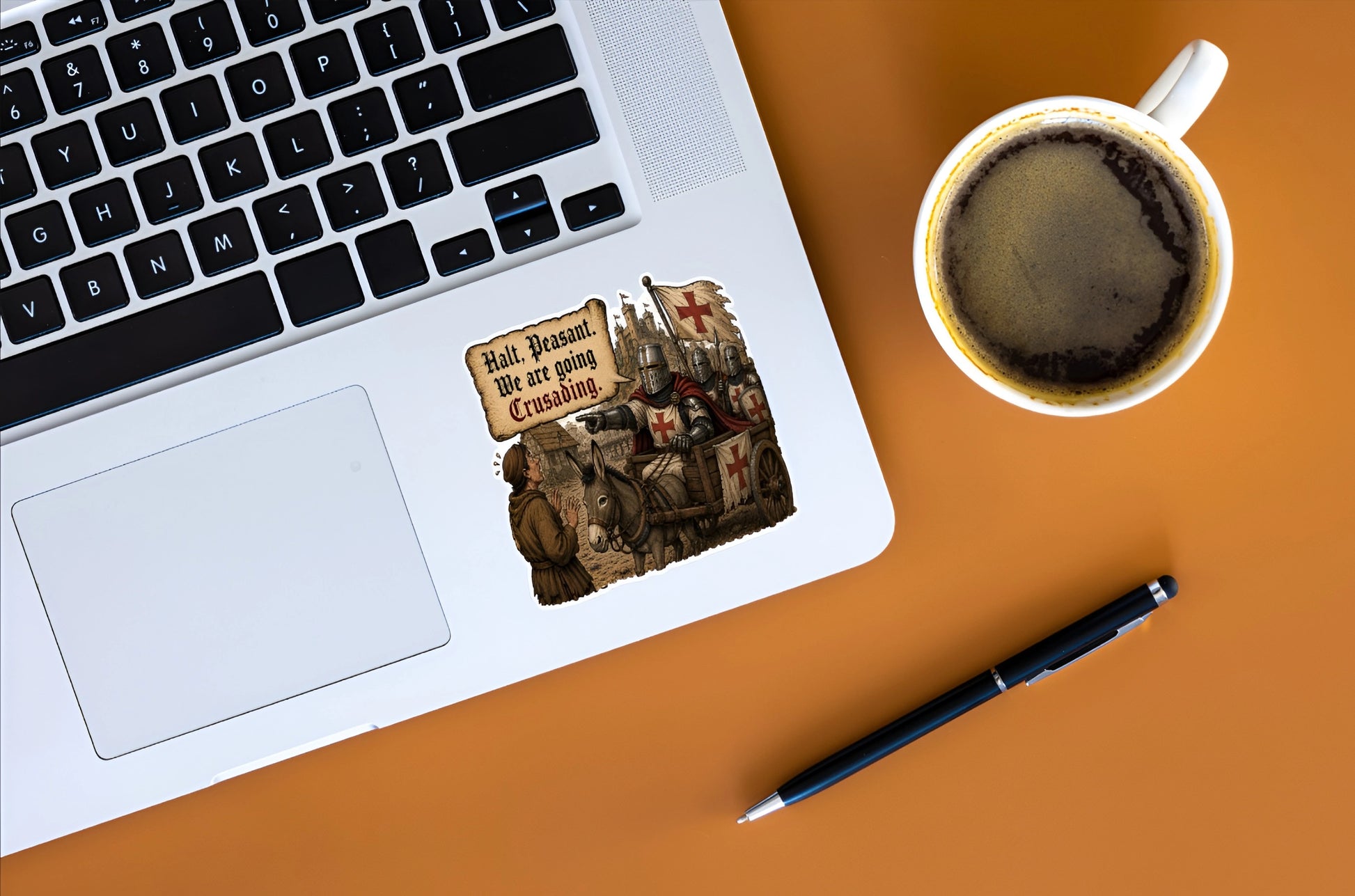 Halt Peasant We Are Going Crusading medieval knight sticker displayed on a silver laptop beside coffee