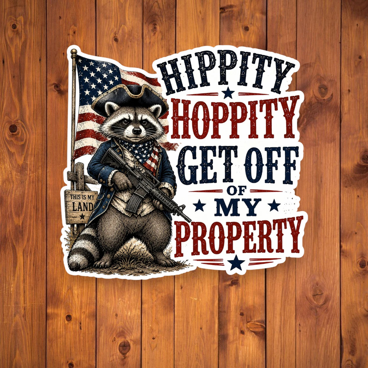 Sticker with a raccoon holding an American flag and text on a wooden background