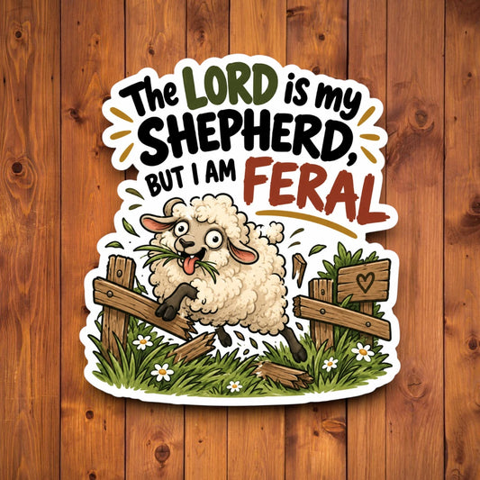 A die-cut sticker featuring a cartoon sheep jumping over a wooden fence with the text 'The LORD is my SHEEPHERD, BUT I AM FERAL' on a brown wood plank background.