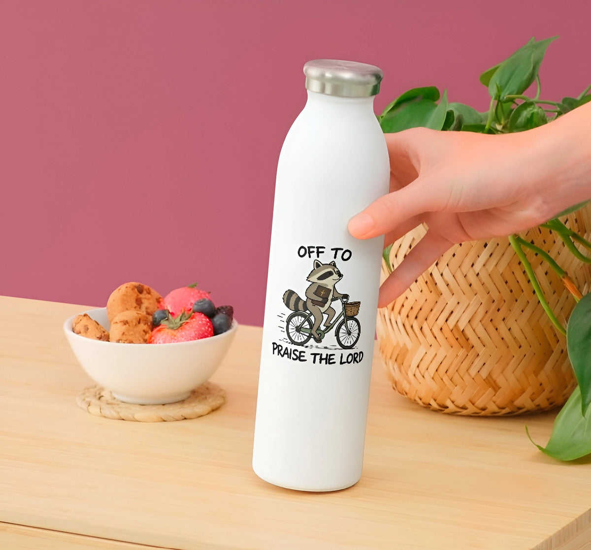 Funny Christian raccoon sticker with Off to Praise the Lord quote displayed on a white water bottle