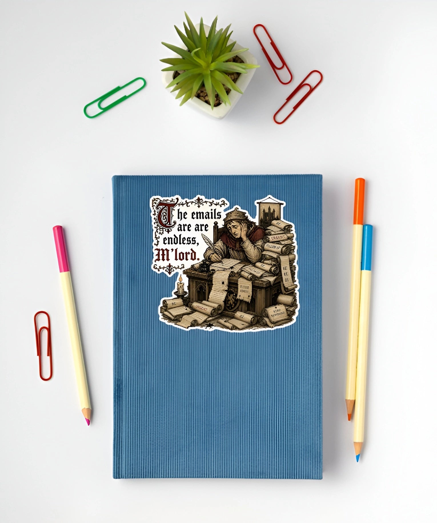 Funny medieval office sticker with endless emails quote displayed on a blue notebook