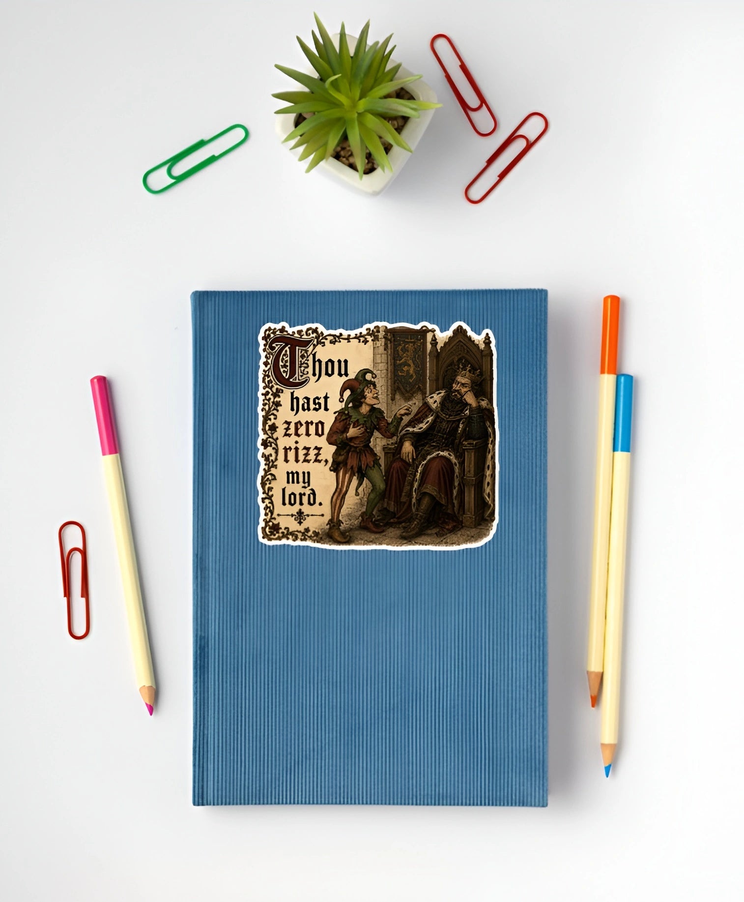 Thou Hast Zero Rizz My Lord medieval meme sticker displayed on a blue notebook
