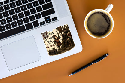 Funny medieval aux cord sticker displayed on a silver laptop beside coffee