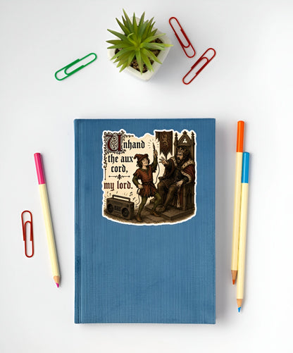 Unhand the Aux Cord My Lord medieval sticker displayed on a blue notebook