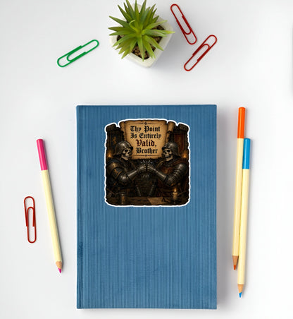 Thy Point Is Entirely Valid Brother medieval skeleton knight sticker displayed on a blue notebook