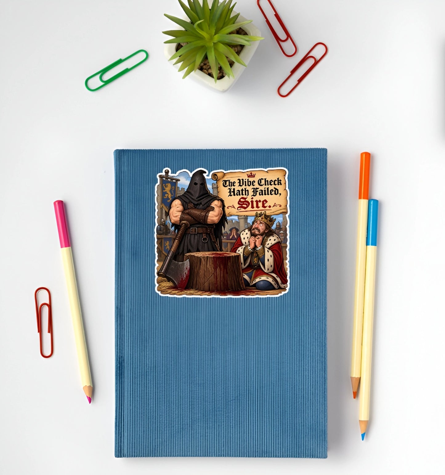 The Vibe Check Hath Failed Sire funny medieval sticker displayed on a blue notebook
