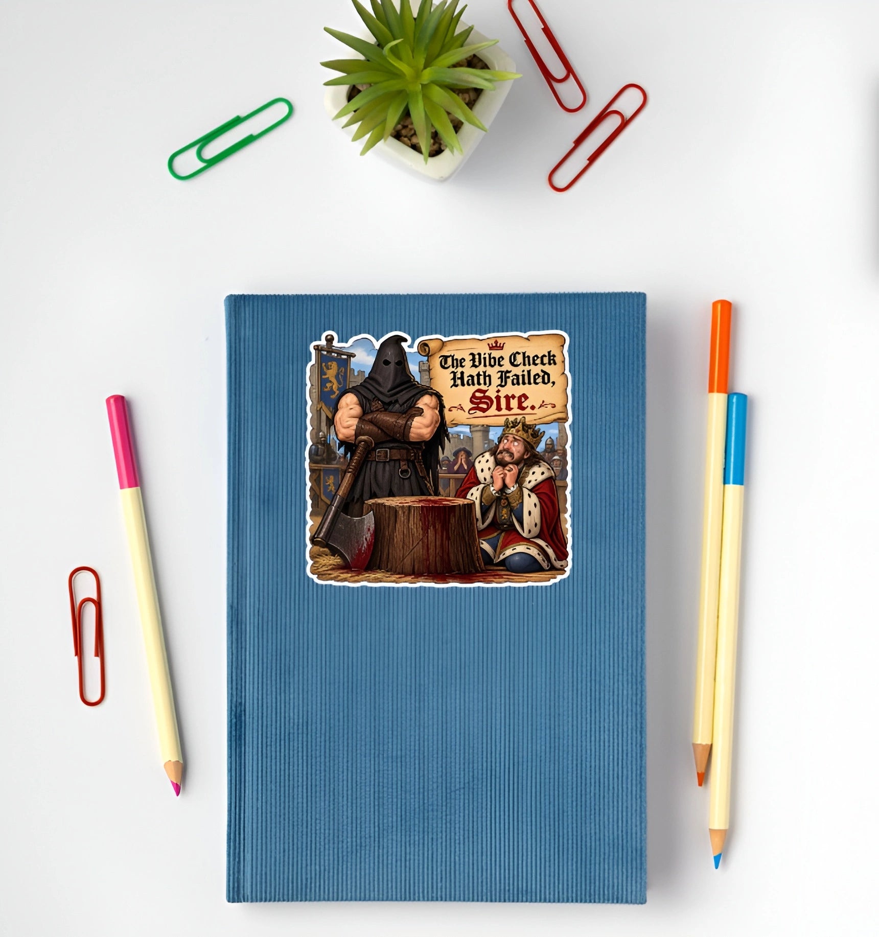 The Vibe Check Hath Failed Sire funny medieval sticker displayed on a blue notebook