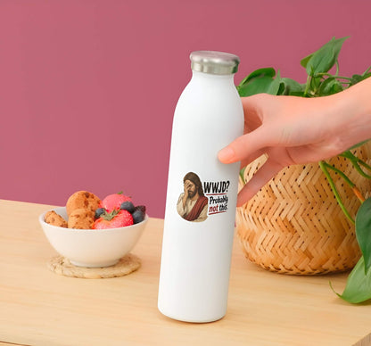 White water bottle with a Jesus wearing cream and red robes, holding his hand over his face in an exhausted facepalm gesture next to bold text reading "WWJD? Probably not this." design held by a hand on a wooden table with a bowl of snacks and a plant.