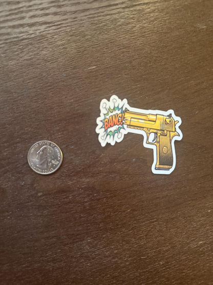Golden Gun Pop Art Sticker | "BANG!" Comic Book Decal | Unique Weapon Art | Retro Pop Culture Vinyl | Laptop Sticker | Water Bottle Sticker