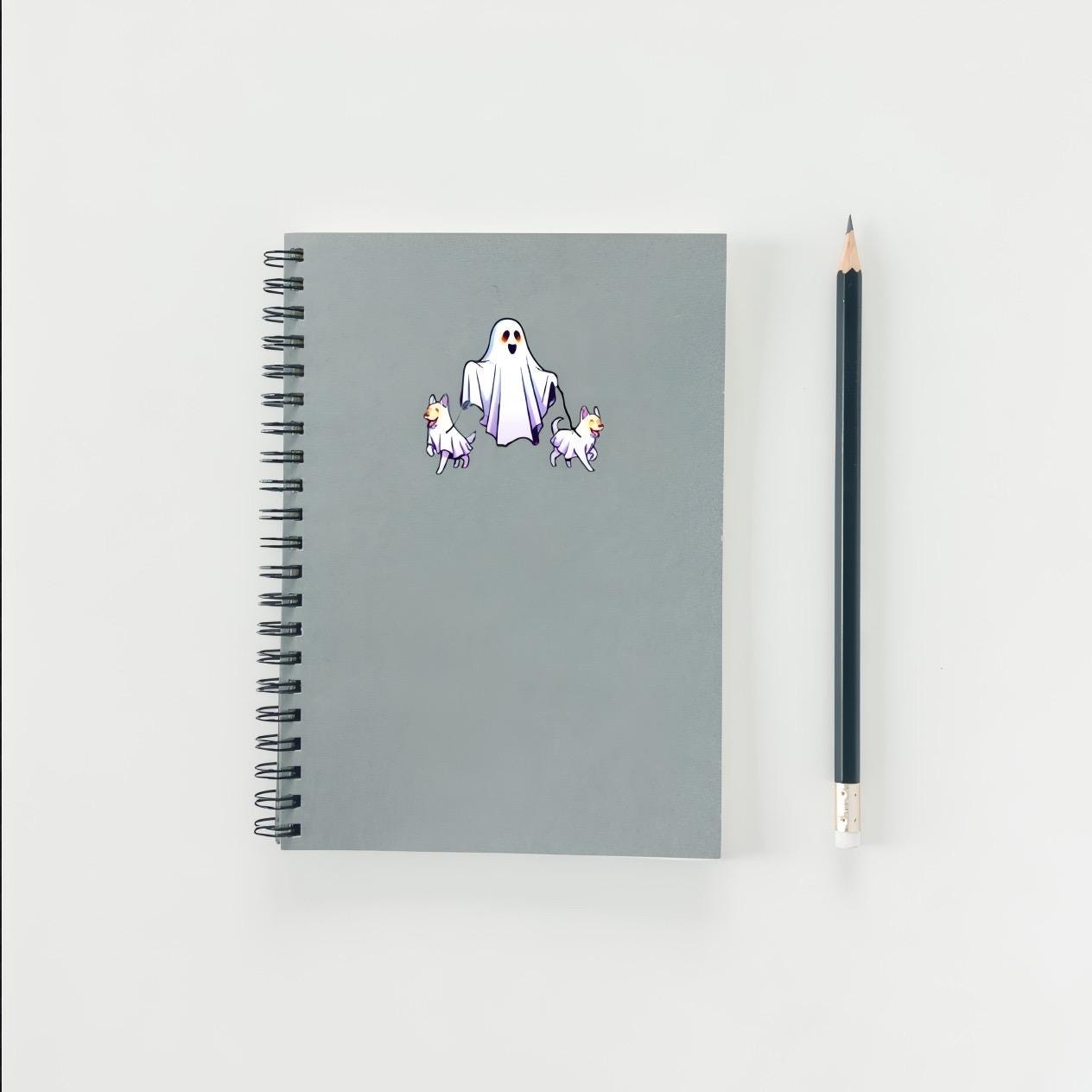 Gray notebook with ghost and dog stickers on a white background