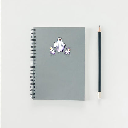 Gray notebook with ghost and dog stickers on a white background