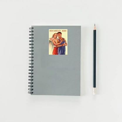 Gray spiral-bound notebook with vintage-style cover and a pencil on a light gray background