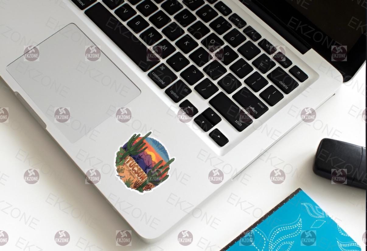 Laptop with a sticker on the palm rest area, placed on a white surface.