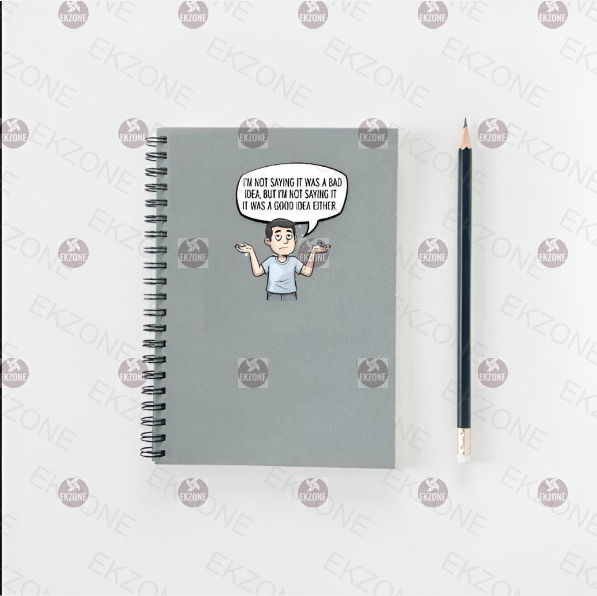 Notebook with a cartoon sticker and a pencil on a white background.