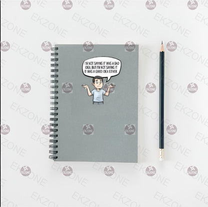 Notebook with a cartoon sticker and a pencil on a white background.