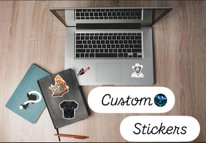 A clean, visually appealing arrangement of various custom-shaped vinyl stickers overlapping each other on a neutral backdrop, showcasing personalized text, custom business logos, and unique custom-cut die-cut edges.