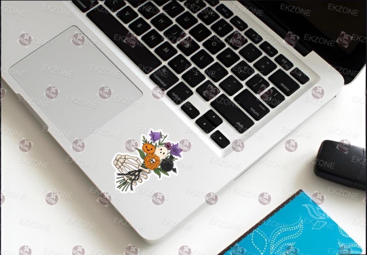 Laptop with decorative stickers on a white surface