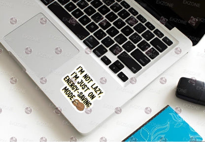 Laptop with a sticker on the keyboard area, placed on a white surface.