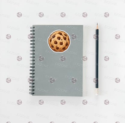 Gray notebook with a cookie design on the cover, next to a pencil on a white background.
