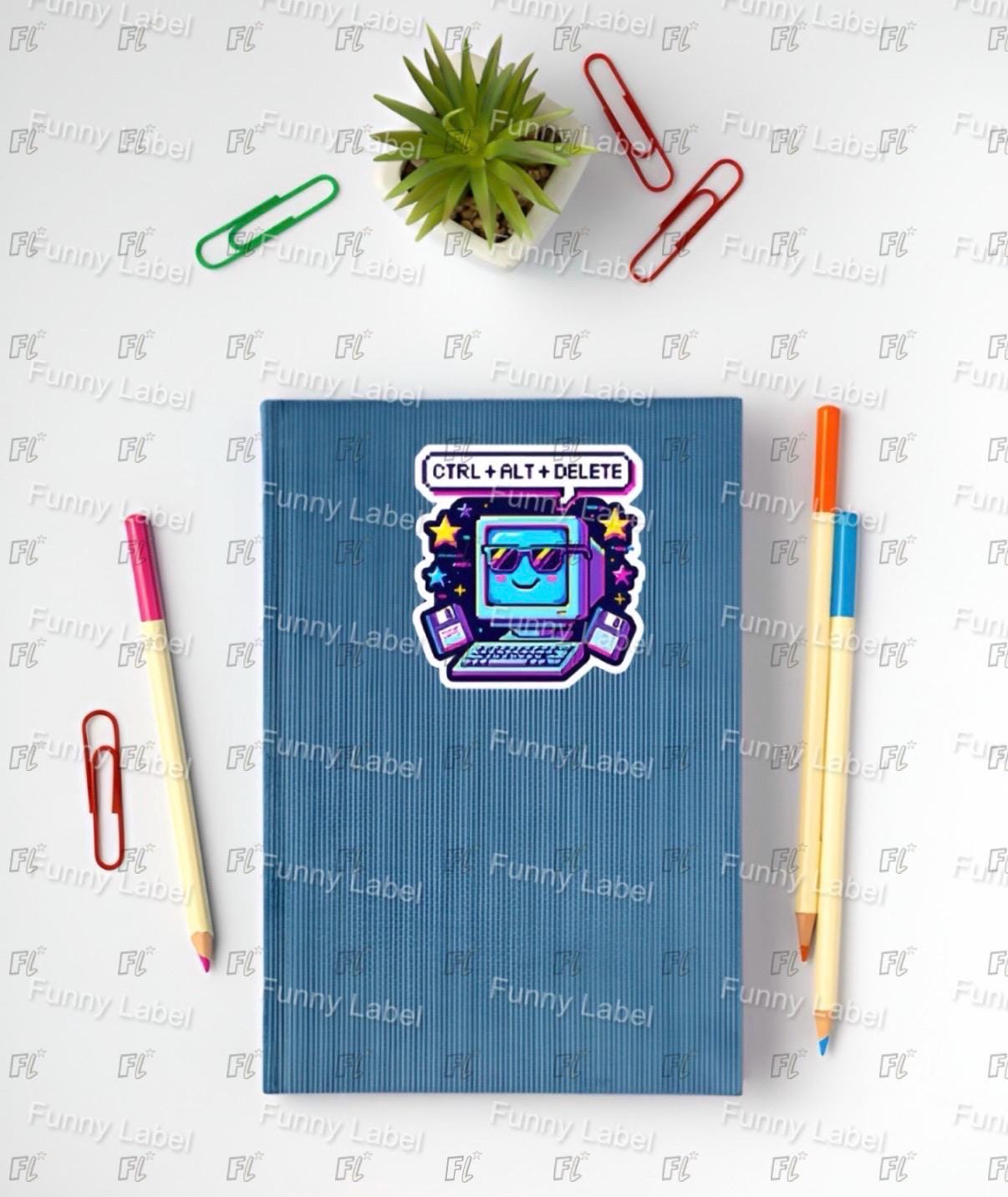 Blue notebook with a sticker on a white surface with stationery items