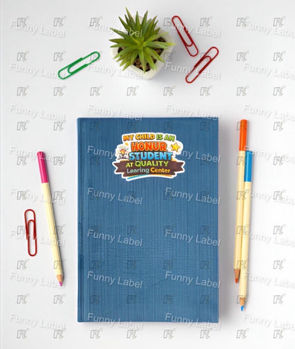 Blue notebook with a sticker on a white surface with stationery items