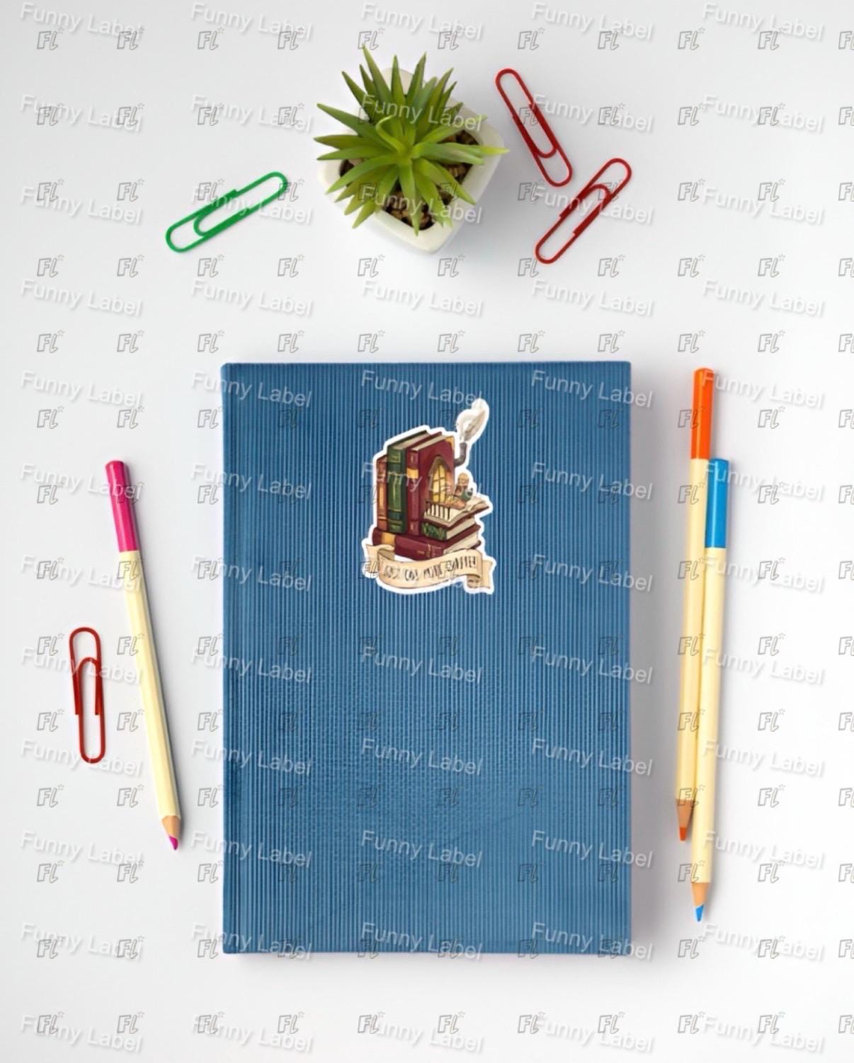Blue notebook with stickers on a white surface with stationery items