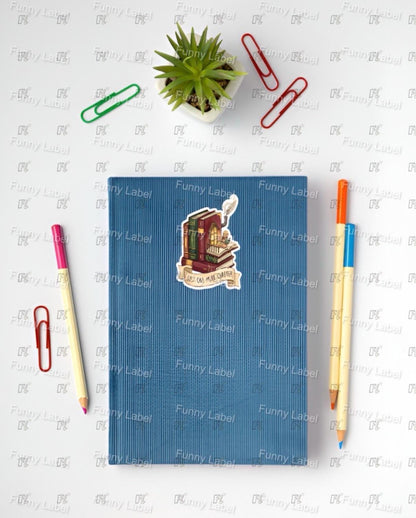 Blue notebook with stickers on a white surface with stationery items
