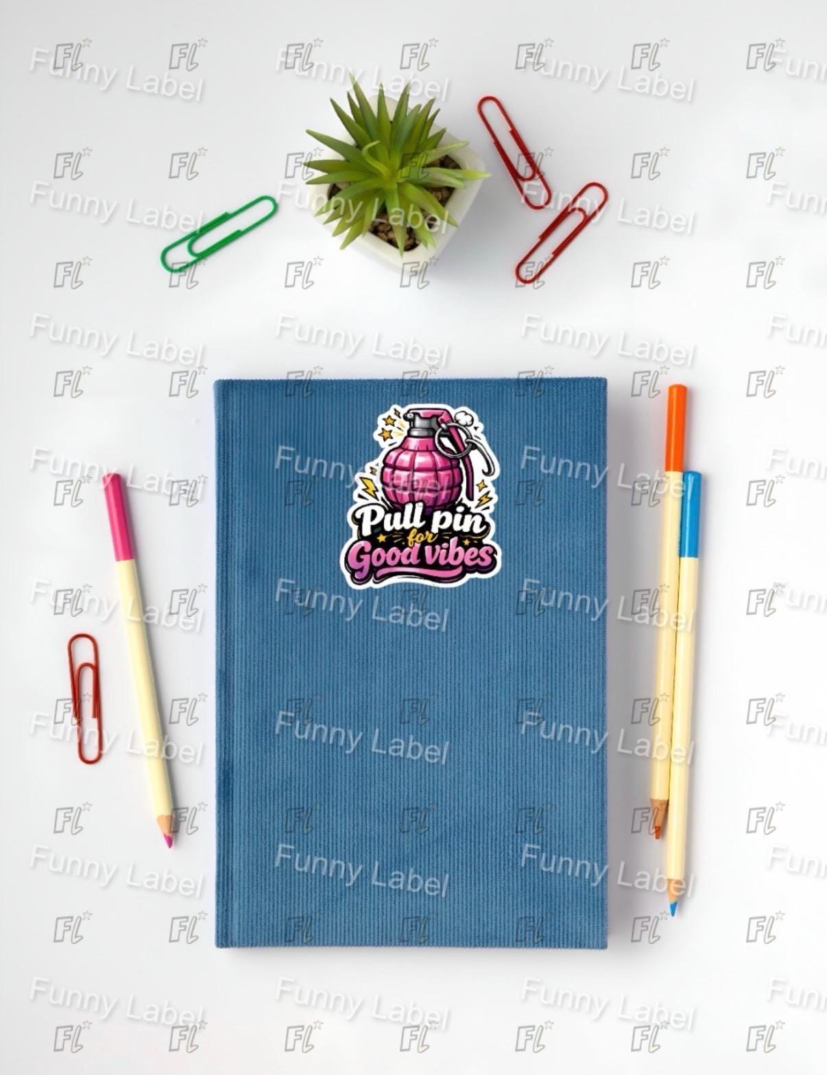 Blue notebook with a sticker on a white surface with stationery items