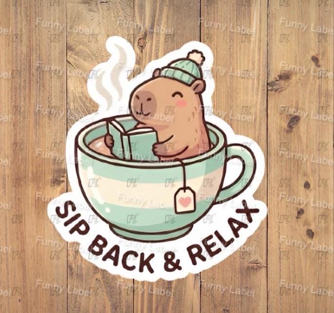 Sticker of a bear in a tea cup with 'Sip Back & Relax' text on a wooden background