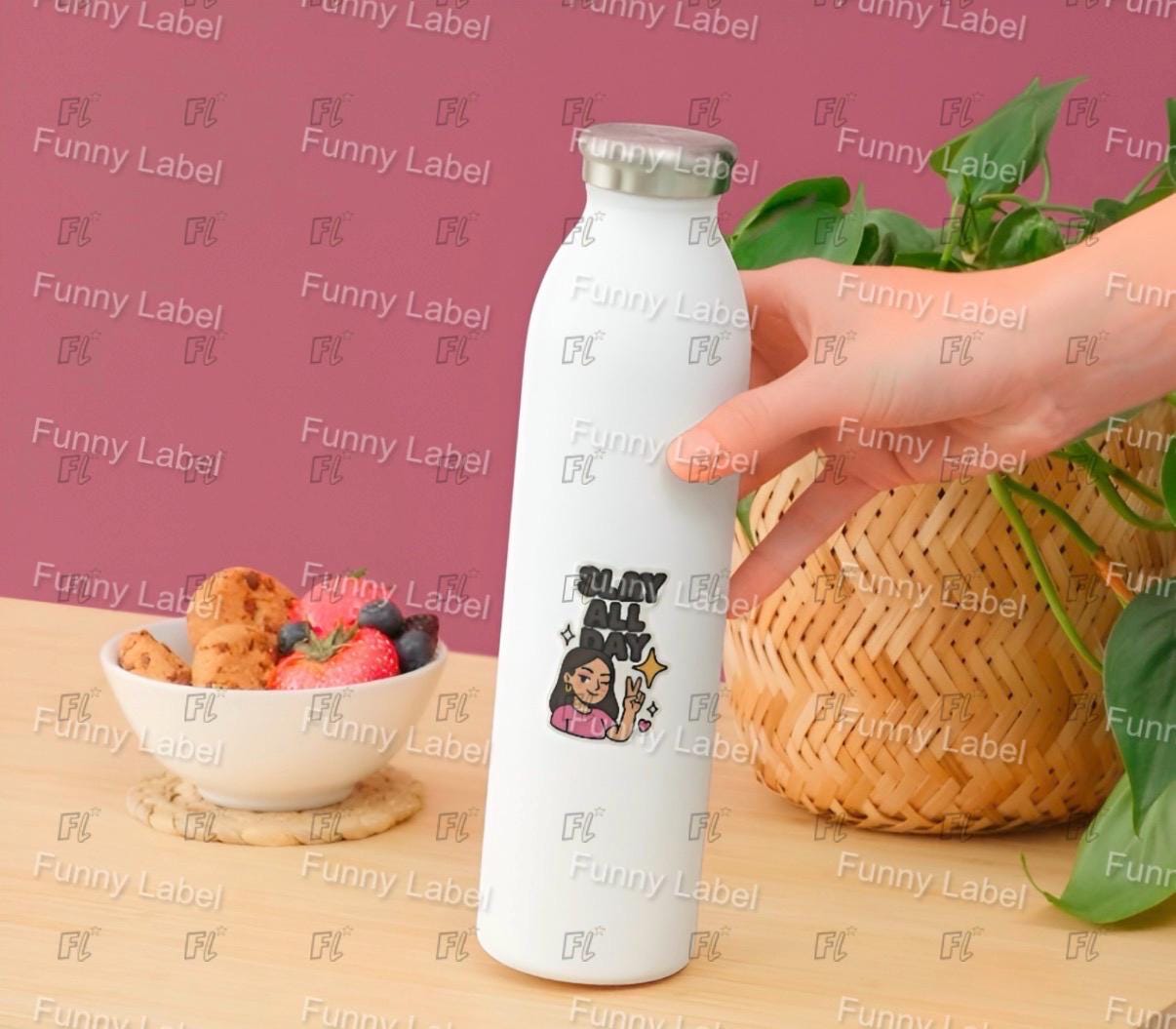 White water bottle with a design held by a hand on a wooden surface with food and plants.
